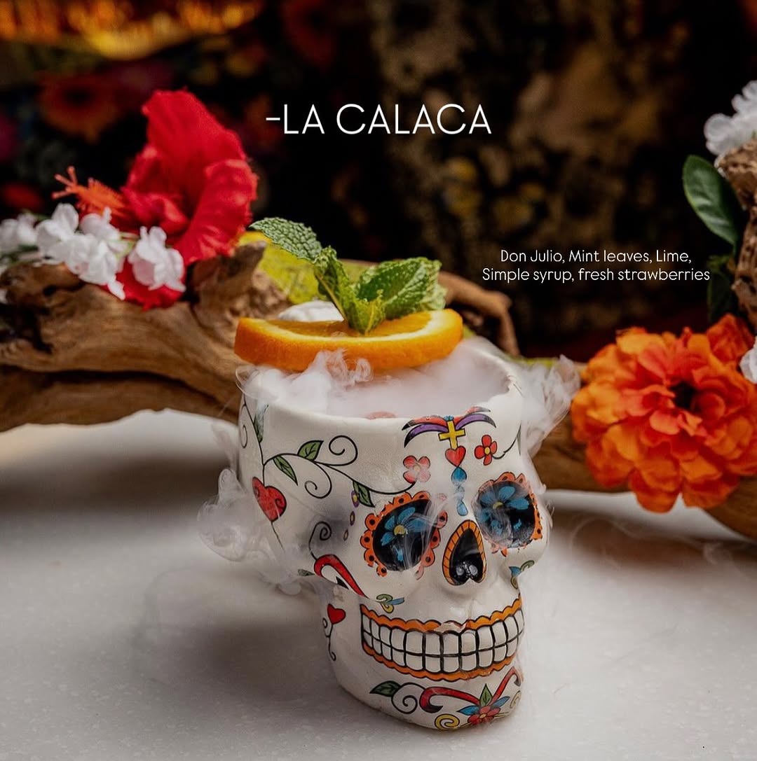 La Calaca — smoking cocktail in a hand-painted sugar-skull mug