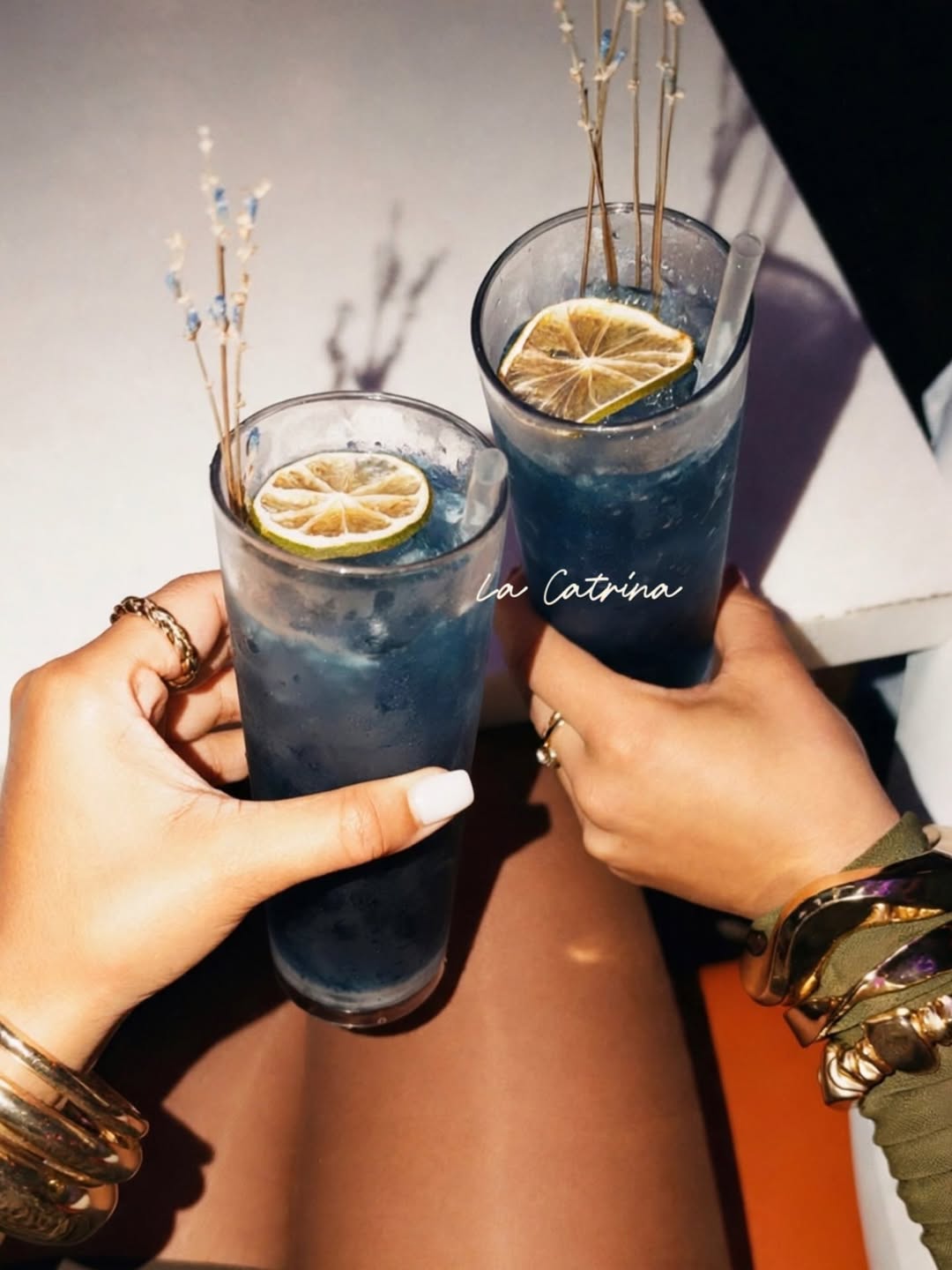 Purple Rain cocktails — two deep-blue tequila drinks raised in a cheers